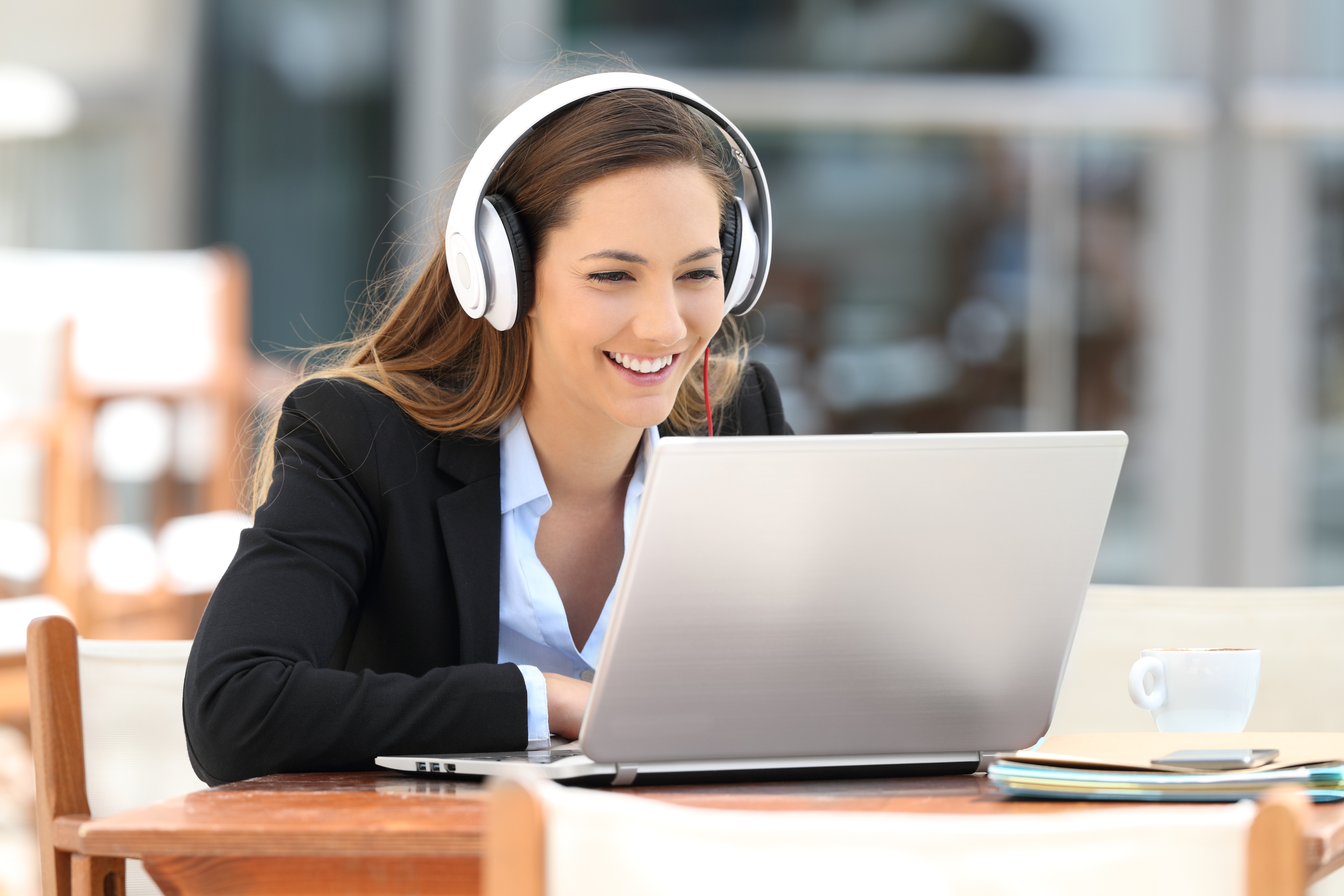 Cheerful woman listening to audio document 
